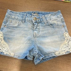 Super cute brand new justice stone washed jean shorts with lace. Size 10.